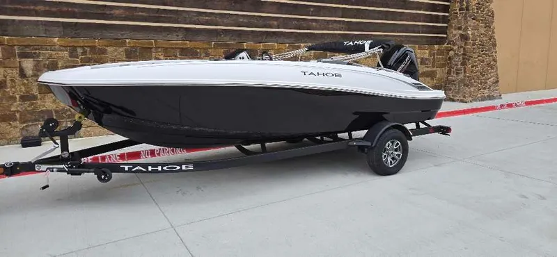 Slide: The Image of 2025 Tahoe T18 boat on trailer, sleek black and white design. - 0
