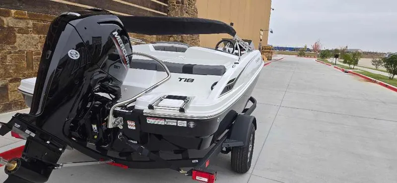 Slide: The Image of 2025 Tahoe T18 boat on trailer, parked outdoors, showcasing sleek design and powerful engine. - 5