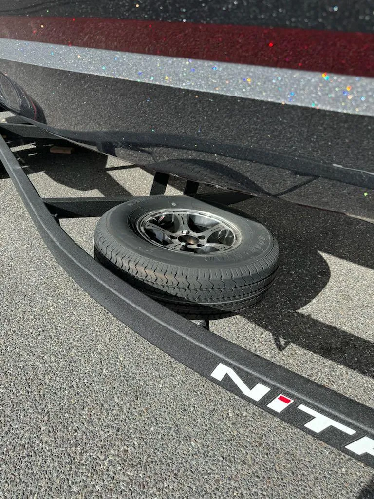 Slide: The Image of 2025 Nitro Z21 XL trailer with spare tire on asphalt. - 17