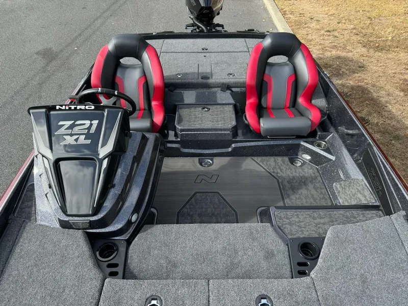 Slide: The Image of 2025 Nitro Z21 XL boat interior with red and black seats, spacious deck. - 5