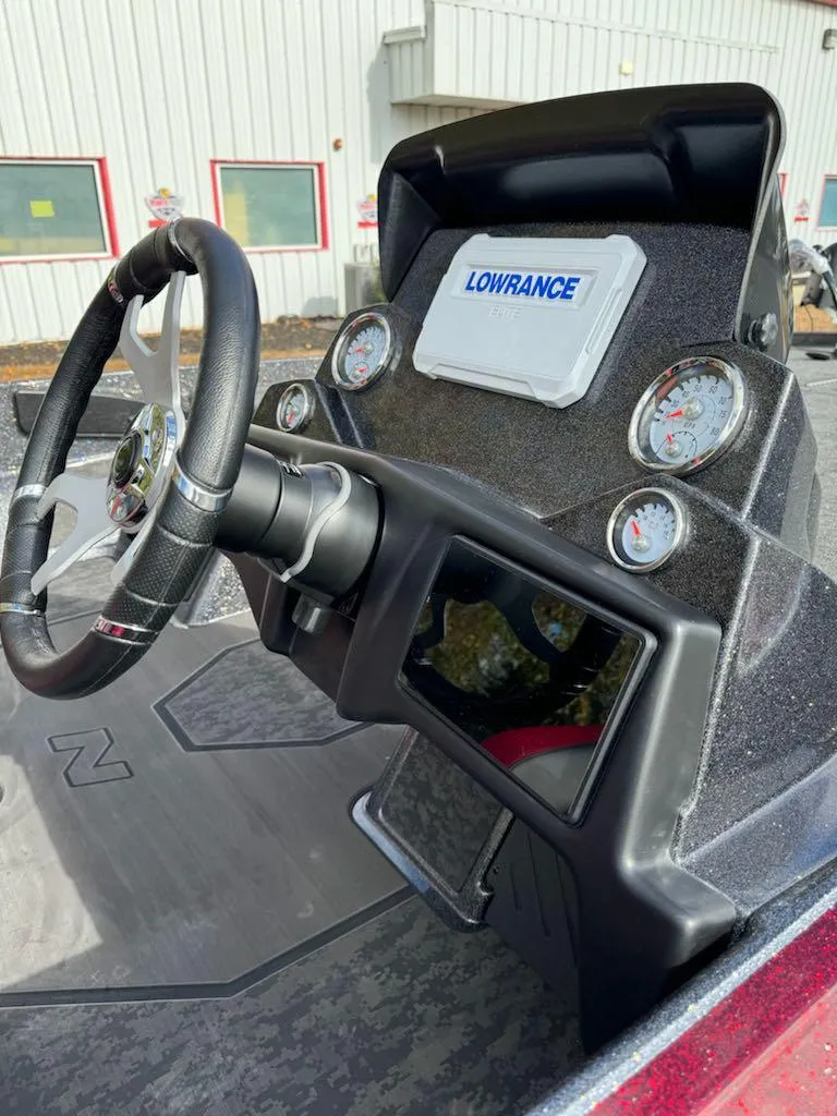 Slide: The Image of 2025 Nitro Z21 XL boat dashboard with Lowrance electronics and steering wheel. - 8