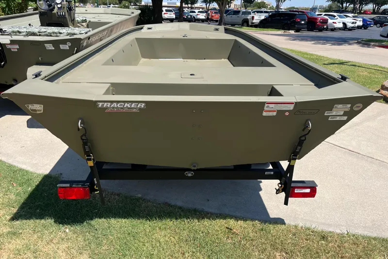 Slide: The Image of 2025 Tracker Grizzly 1754 Jon boat on trailer, parked outdoors. - 2
