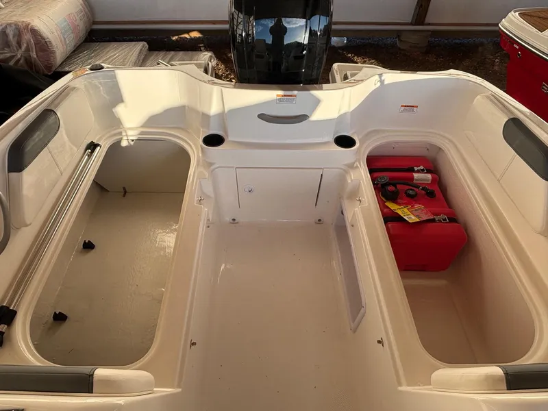 Slide: The Image of 2025 Bayliner E18LE boat interior with storage compartments and seating. - 5