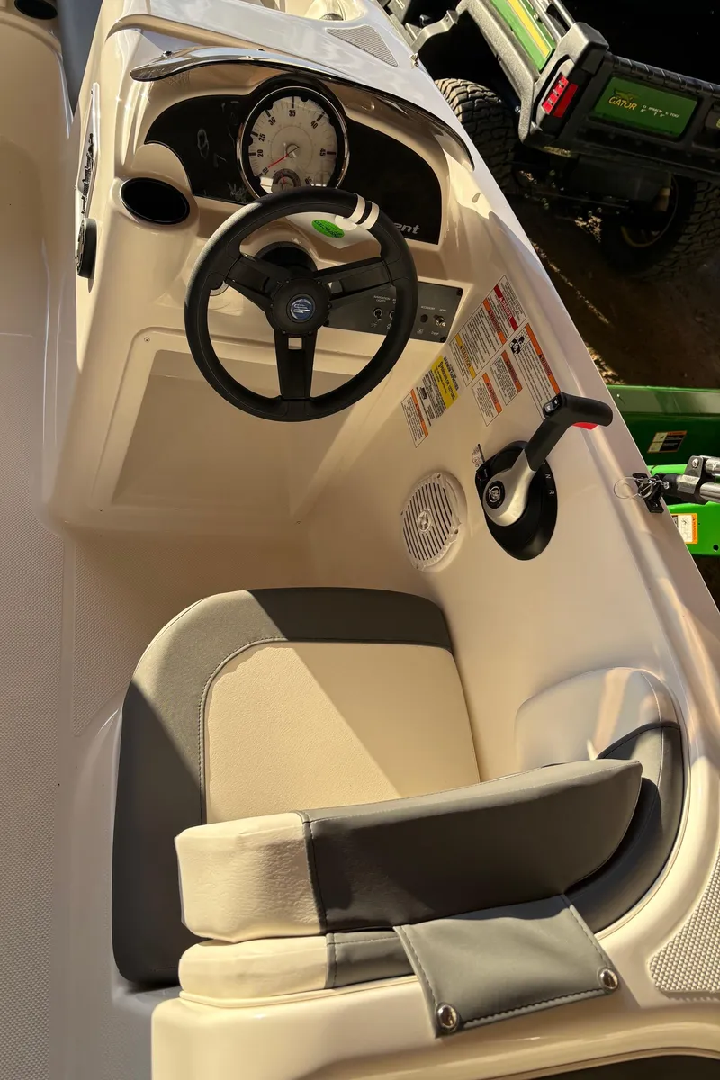 Slide: The Image of 2025 Bayliner E18LE boat cockpit with steering wheel and control panel. - 8