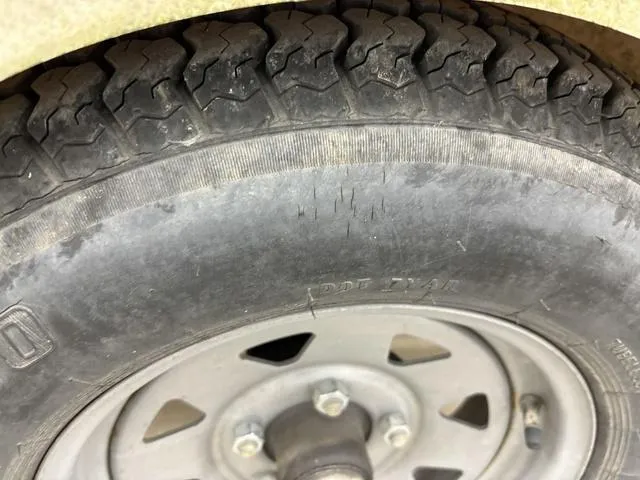 Slide: The Image of Close-up of a worn tire on a 2007 Bayliner 175 Bowrider trailer. - 11