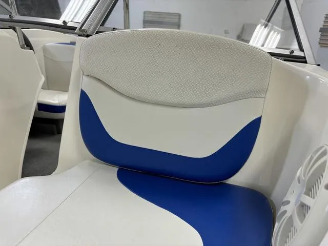 Slide: The Image of 2007 Bayliner 175 Bowrider interior with blue and white seating. - 17
