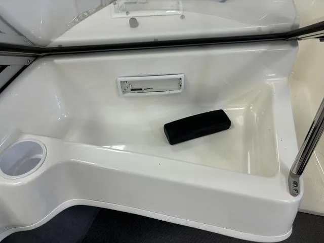 Slide: The Image of 2007 Bayliner 175 Bowrider interior detail with cup holder and storage compartment. - 24