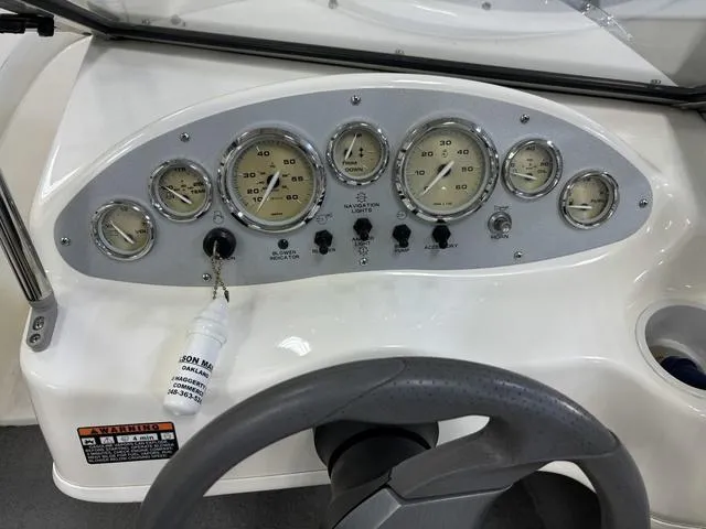 Slide: The Image of Dashboard of a 2007 Bayliner 175 Bowrider boat with gauges and steering wheel. - 26