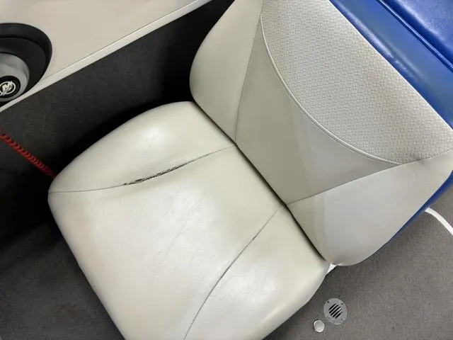 Slide: The Image of 2007 Bayliner 175 Bowrider seat with slight tear, white and blue upholstery. - 28