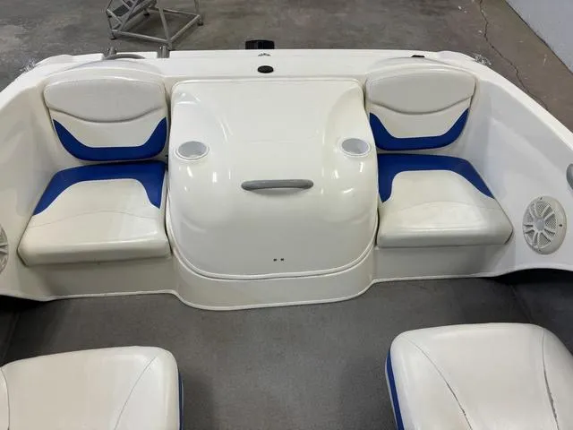 Slide: The Image of 2007 Bayliner 175 Bowrider interior with white and blue seating, cup holders, and speakers. - 30