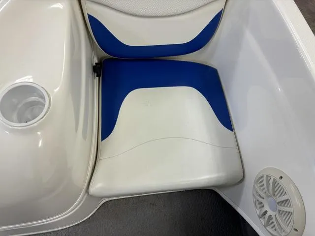 Slide: The Image of 2007 Bayliner 175 Bowrider seat with blue and white upholstery, cup holder, and speaker. - 32