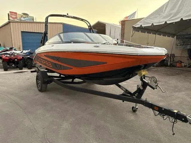 Slide: The Image of 2025 Scarab 195 LX boat, front view, sleek design, white and orange accents. - 13