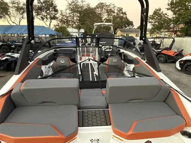 Slide: The Image of 2025 Scarab 195 LX boat with orange and black design on a trailer. - 7