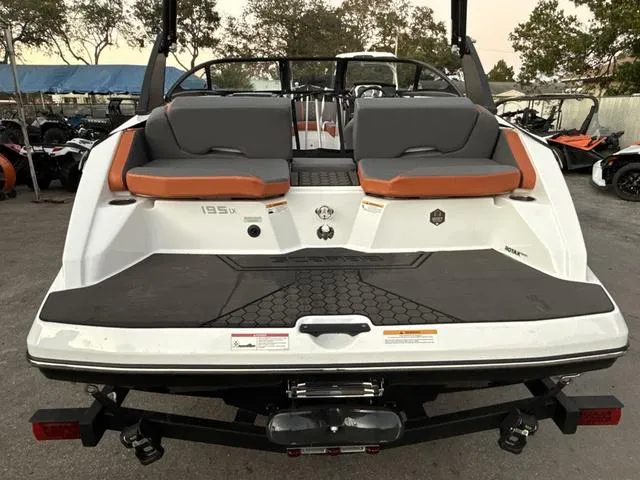 Slide: The Image of 2025 Scarab 195 LX boat, rear view, featuring dual seating and sleek design. - 8