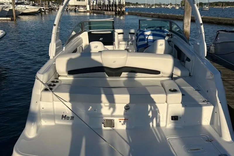 Slide: The Image of 2022 Four Winns HD3 OB RS boat docked at marina, rear view. - 3