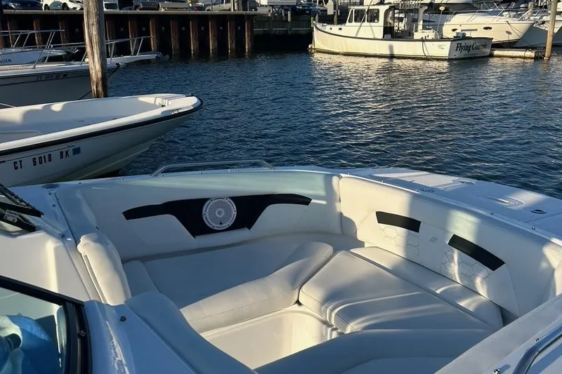 Slide: The Image of 2022 Four Winns HD3 OB RS boat interior at marina, featuring spacious seating. - 5