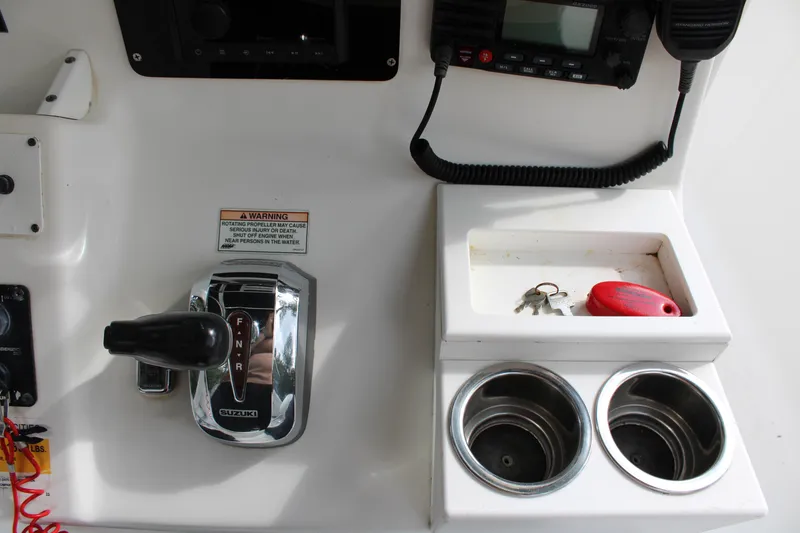 Slide: The Image of Boat control panel with throttle, cup holders, and keys on a 2009 Sea Fox 256CC Pro Series. - 10