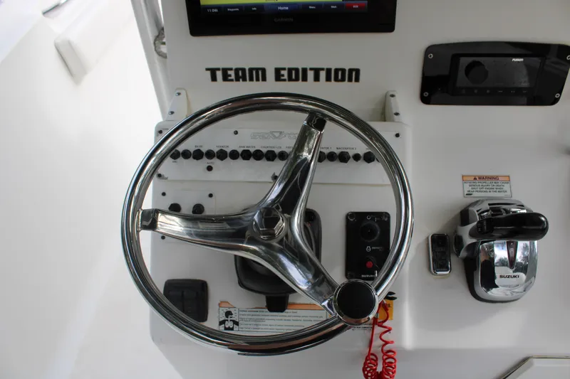 Slide: The Image of 2009 Sea Fox 256CC Pro Series helm with steering wheel and controls. - 11