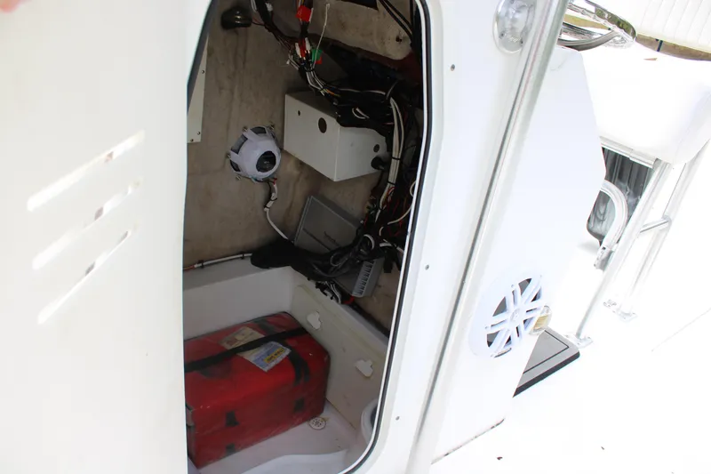 Slide: The Image of 2009 Sea Fox 256CC Pro Series boat storage compartment with wiring and equipment. - 14