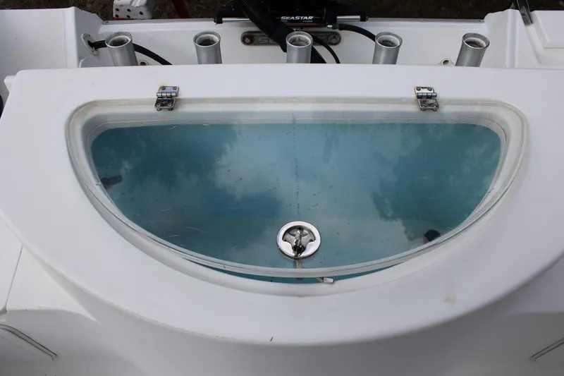 Slide: The Image of Livewell on 2009 Sea Fox 256CC Pro Series boat, featuring rod holders and clear lid. - 2