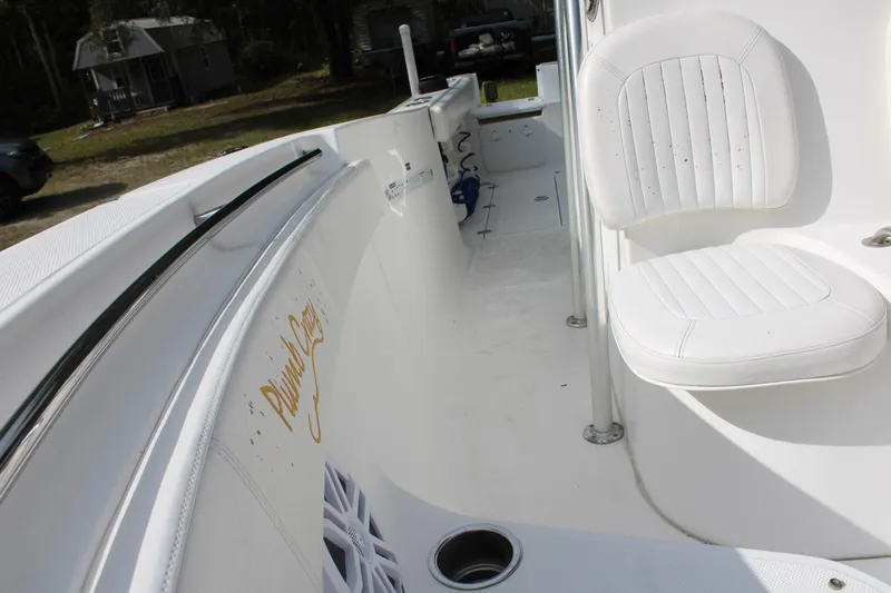 Slide: The Image of 2009 Sea Fox 256CC Pro Series boat interior with white seating and clean deck. - 26