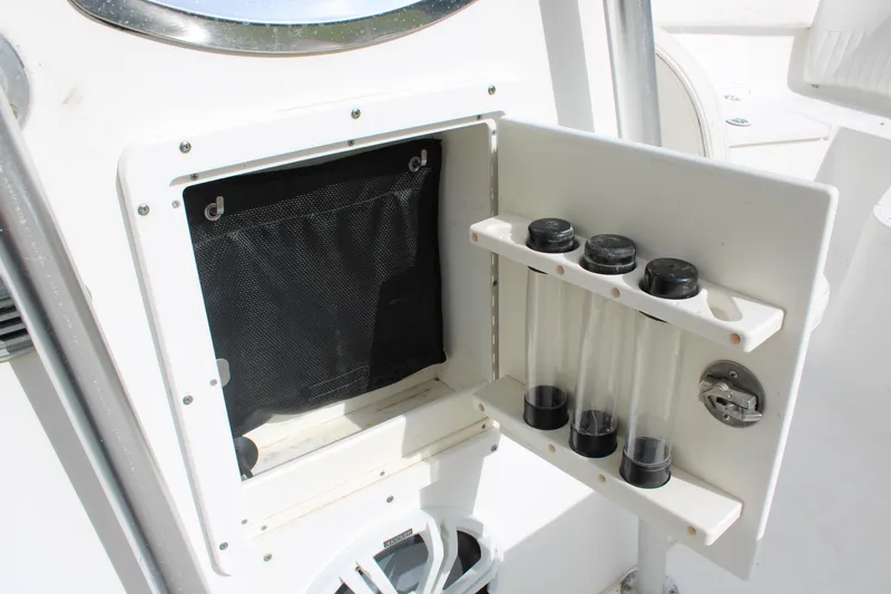 Slide: The Image of 2009 Sea Fox 256CC Pro Series boat storage compartment with rod holders. - 31