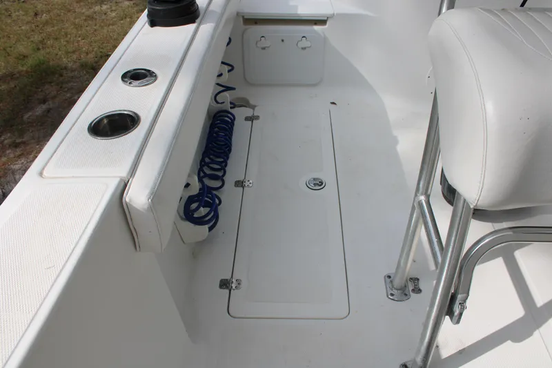 Slide: The Image of 2009 Sea Fox 256CC Pro Series boat interior with seating and storage compartments. - 32
