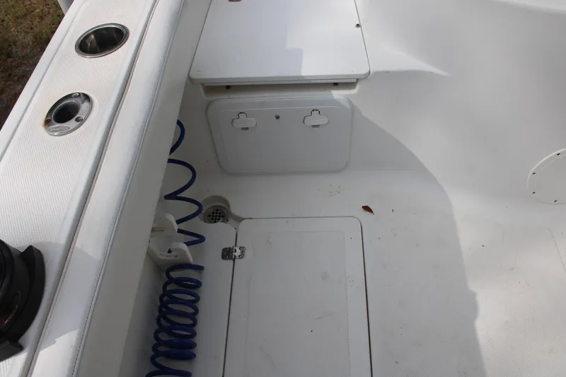 Slide: The Image of 2009 Sea Fox 256CC Pro Series boat interior with storage compartments and cup holders. - 33