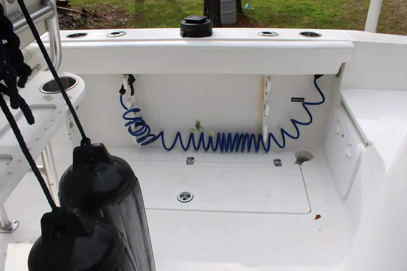 Slide: The Image of 2009 Sea Fox 256CC Pro Series boat deck with storage and coiled hose. - 35
