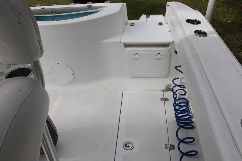 Slide: The Image of 2009 Sea Fox 256CC Pro Series boat interior with storage and coiled hose. - 37