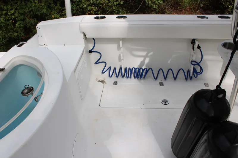 Slide: The Image of 2009 Sea Fox 256CC Pro Series boat interior with coiled hose and storage compartments. - 38