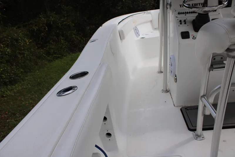 Slide: The Image of 2009 Sea Fox 256CC Pro Series boat interior with rod holders and seating. - 4