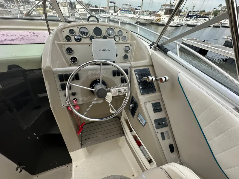 Slide: The Image of 1997 Bayliner 3255 Avanti helm with steering wheel and navigation controls. - 14