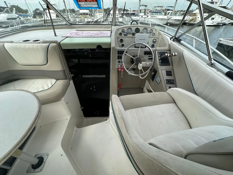 Slide: The Image of 1997 Bayliner 3255 Avanti boat interior with steering wheel and seating area. - 15