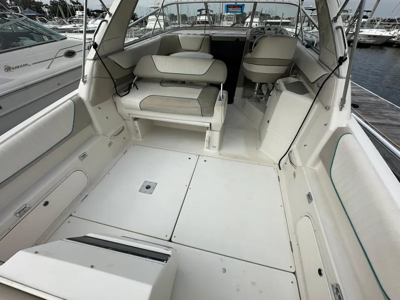 Slide: The Image of 1997 Bayliner 3255 Avanti boat interior with seating and helm, docked at marina. - 19
