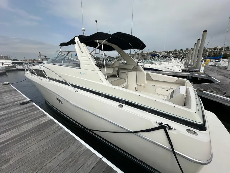 Slide: The Image of 1997 Bayliner 3255 Avanti docked at marina, featuring sleek design and spacious interior. - 2