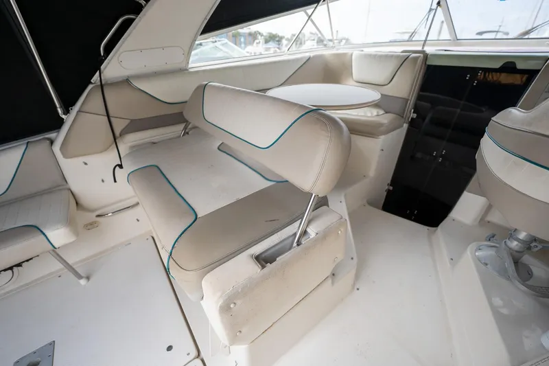 Slide: The Image of 1997 Bayliner 3255 Avanti interior with beige seating and round table. - 20
