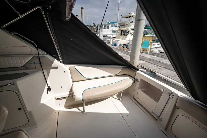 Slide: The Image of 1997 Bayliner 3255 Avanti boat interior with seating, docked at marina. - 24