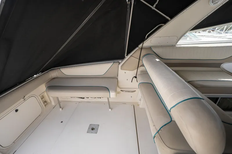 Slide: The Image of Interior seating area of a 1997 Bayliner 3255 Avanti boat with cushioned benches. - 25