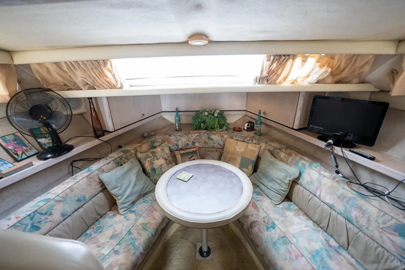 Slide: The Image of Interior of 1997 Bayliner 3255 Avanti boat with cozy seating and table. - 26