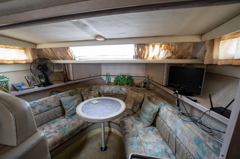 Slide: The Image of Interior of 1997 Bayliner 3255 Avanti boat with cozy seating and table. - 28