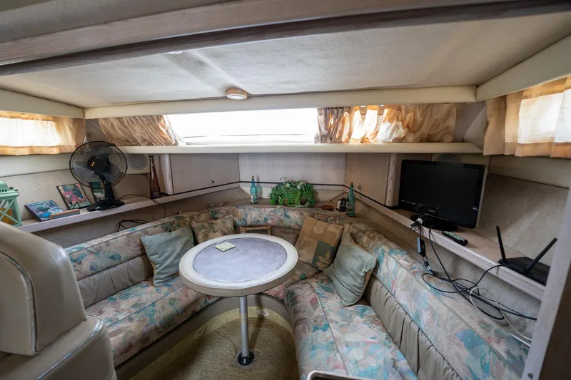 Slide: The Image of Interior of 1997 Bayliner 3255 Avanti boat with cozy seating and table. - 29