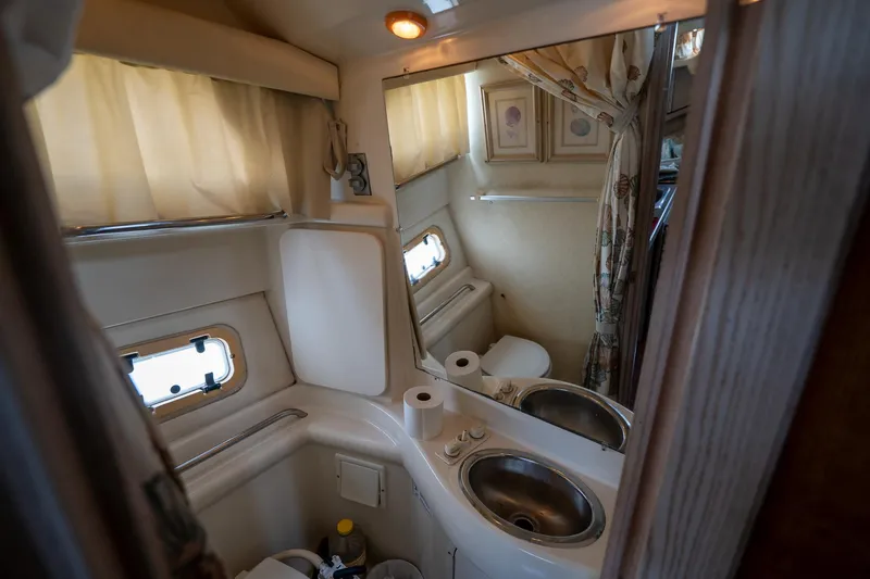 Slide: The Image of Bathroom interior of 1997 Bayliner 3255 Avanti yacht with sink, mirror, and window. - 37