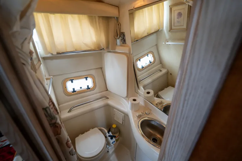 Slide: The Image of Bathroom interior of 1997 Bayliner 3255 Avanti boat with sink and toilet. - 38