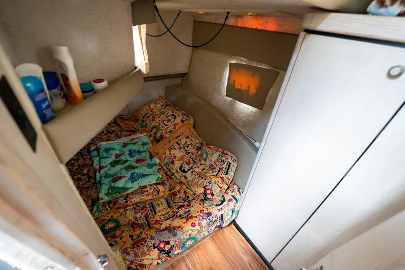 Slide: The Image of 1997 Bayliner 3255 Avanti cabin interior with colorful bedding and toiletries. - 39