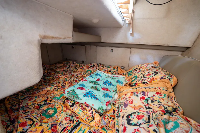 Slide: The Image of Cozy cabin interior of 1997 Bayliner 3255 Avanti with colorful bedding. - 40