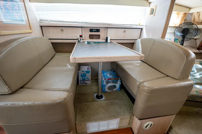 Slide: The Image of Interior of 1997 Bayliner 3255 Avanti with beige seating and dining table. - 41