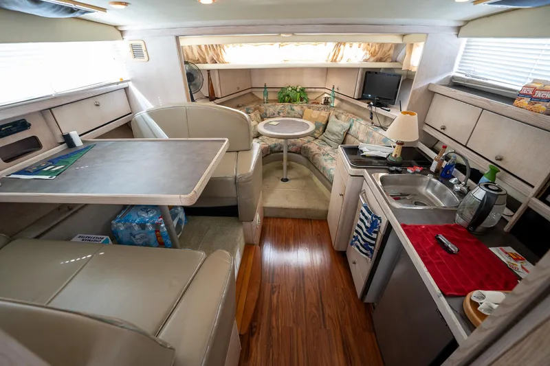 Slide: The Image of Interior of a 1997 Bayliner 3255 Avanti boat with kitchen and seating area. - 42