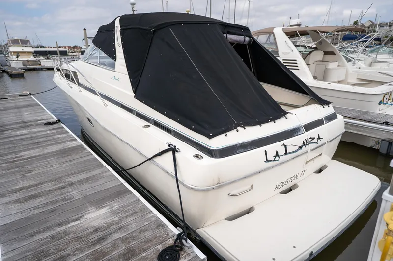 Slide: The Image of Bayliner 3255 Avanti 1997 boat docked with black canopy in marina. - 6