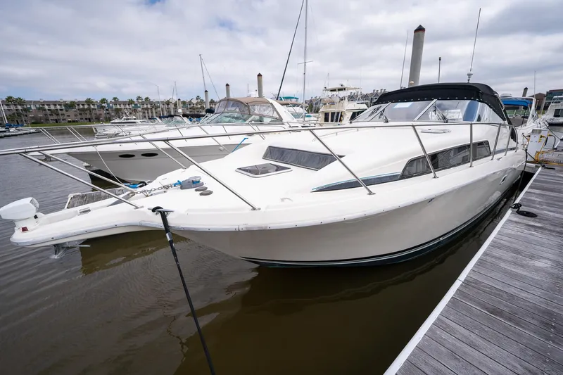 Slide: The Image of Bayliner 3255 Avanti 1997 docked at marina, side view. - 8